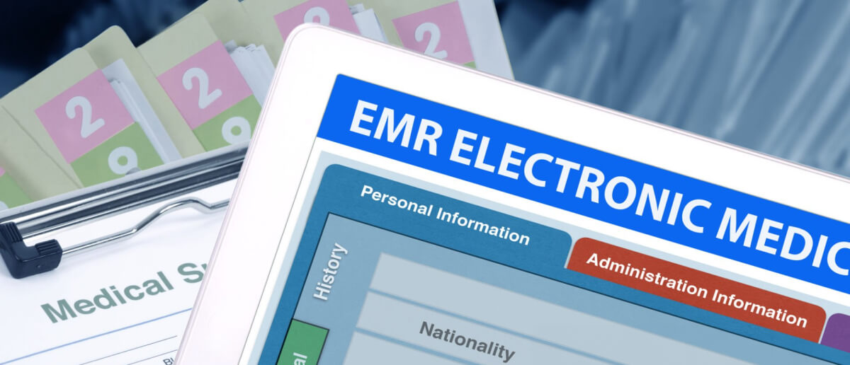 a tablet with an Electronic Medical Record (EMR) interface, contrasting with traditional paper medical files in the background, illustrating the shift towards digitized patient records in healthcare