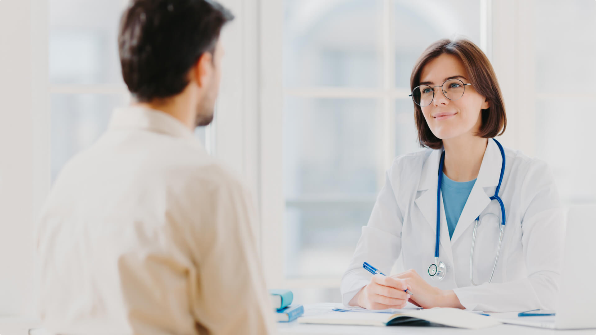 A female doctor consults with a patient, highlighting efficient healthcare interactions.