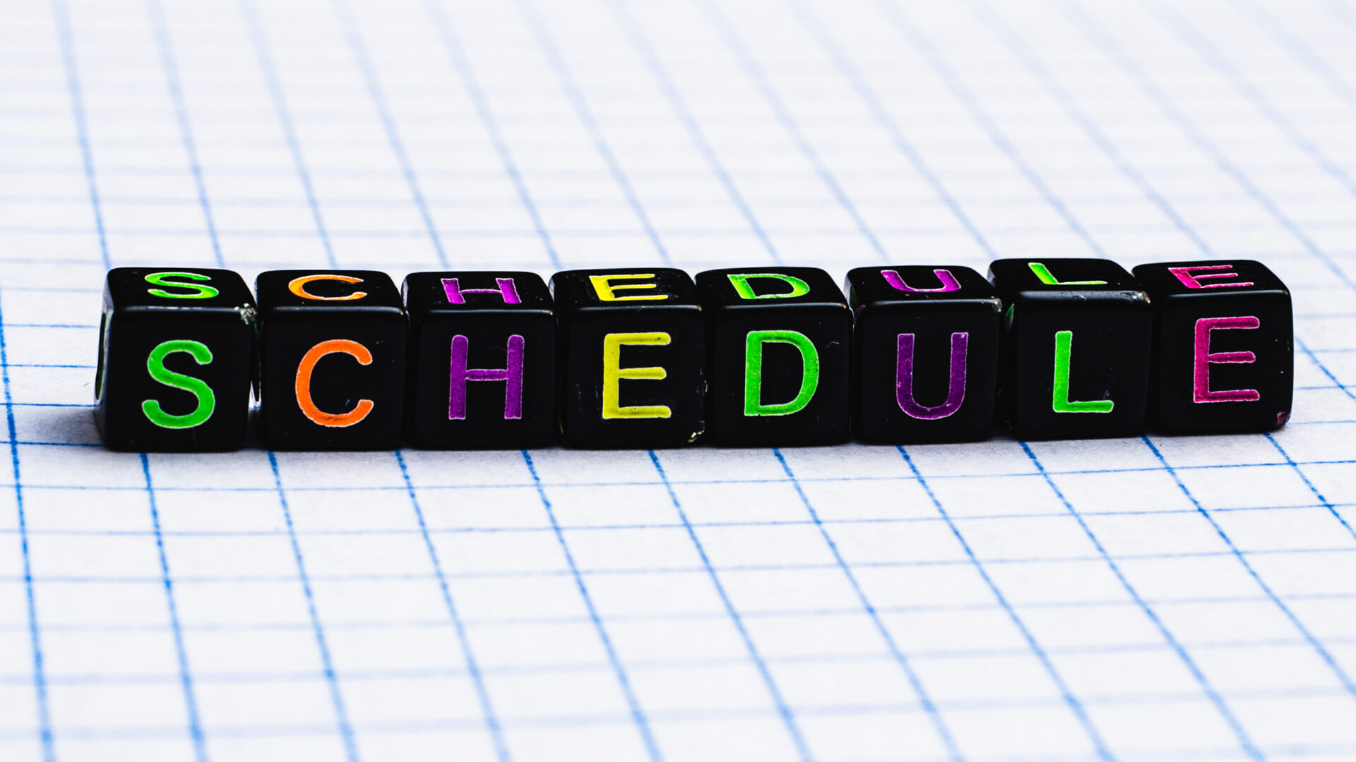 the word schedule spelt out on a piece of paper