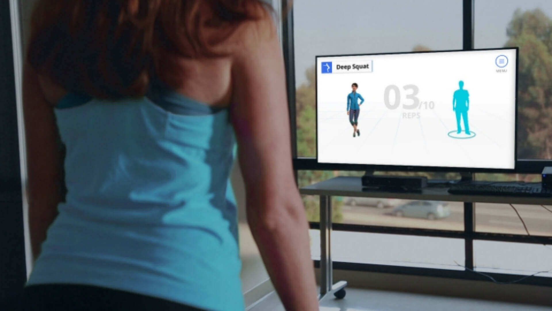 a woman is standing in front of a tv with a fitness app on it