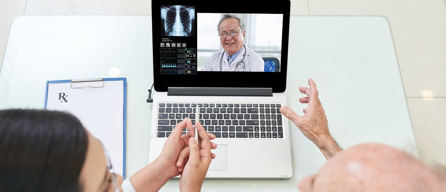 Doctor using telemedicine video consultation app in laptop