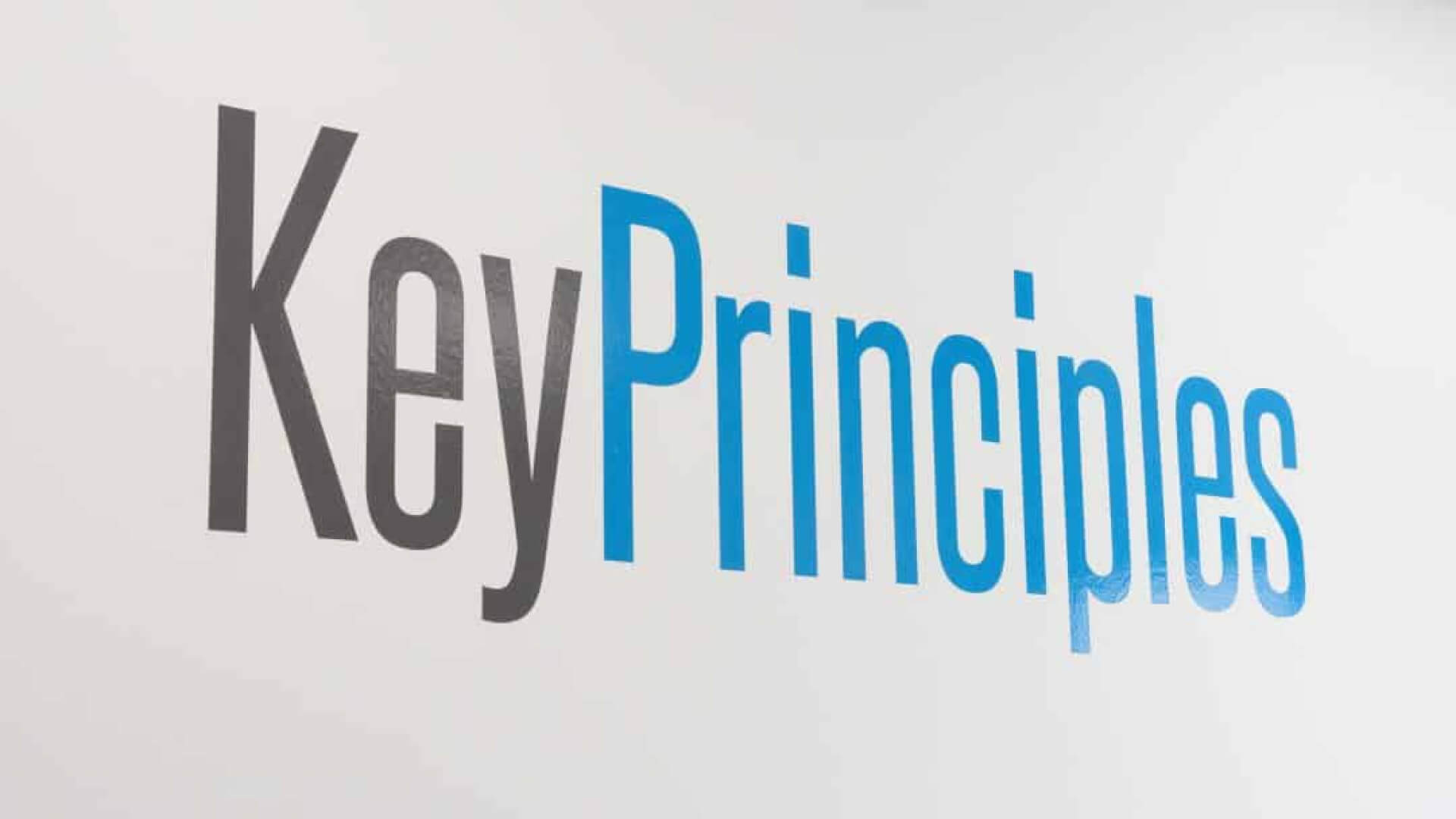 The phrase 'Key Principles' in bold, blue and grey lettering on a white background.
