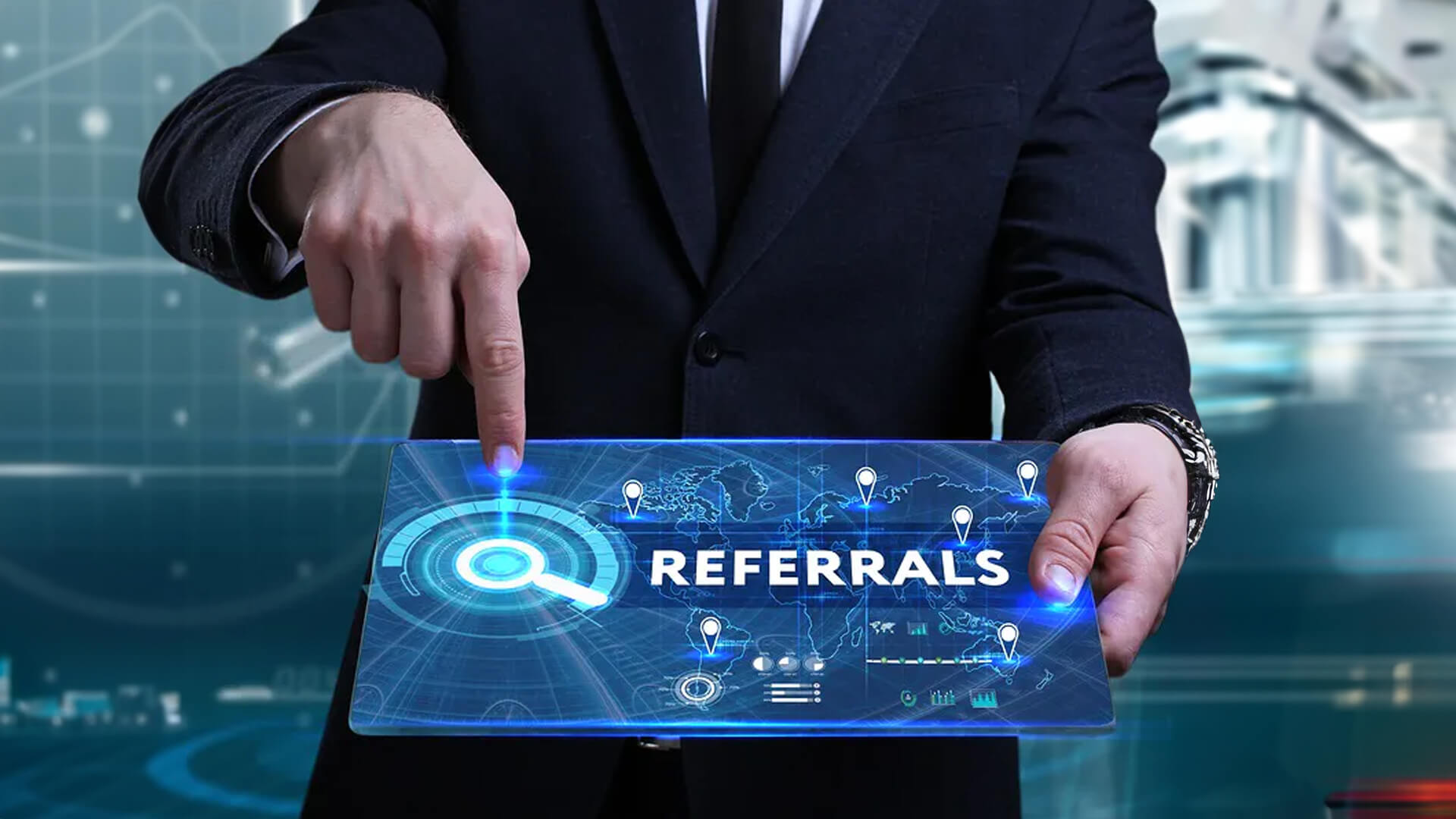 a businessman holding up a tablet with the word referrals on it