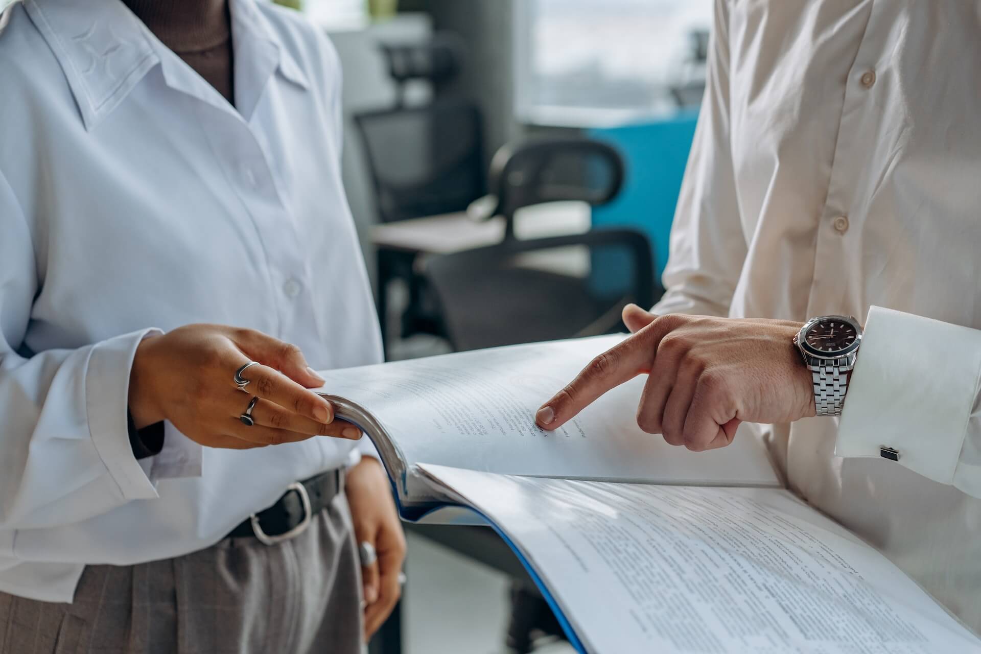 a man and a woman looking at a document