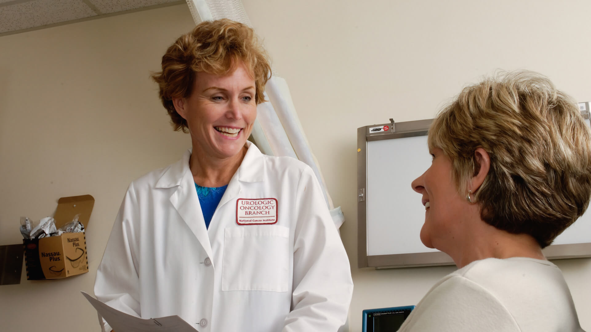 a woman talking to a doctor in a white coat