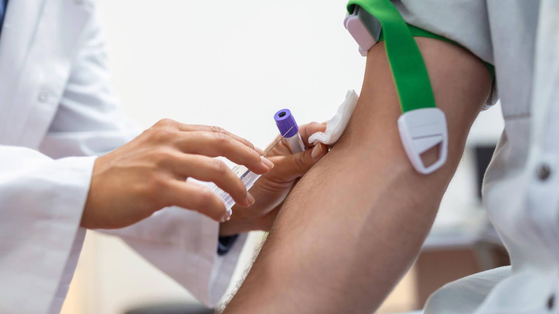 a doctor giving a blood test to a patient