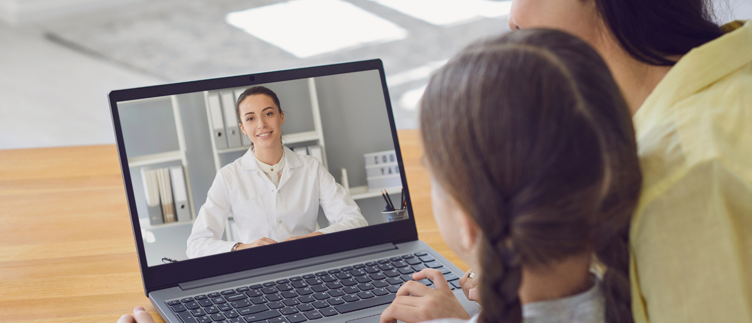 mother and daughter consulting with doctor using telemedicine web app in laptop