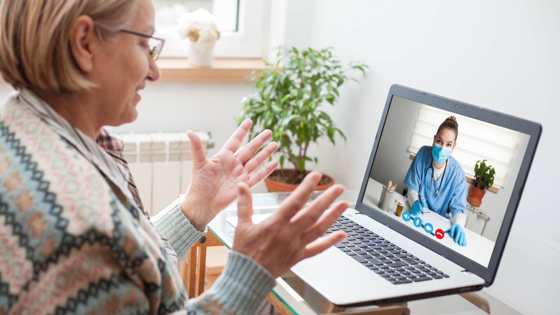 a woman on a laptop talking to a doctor on a video call