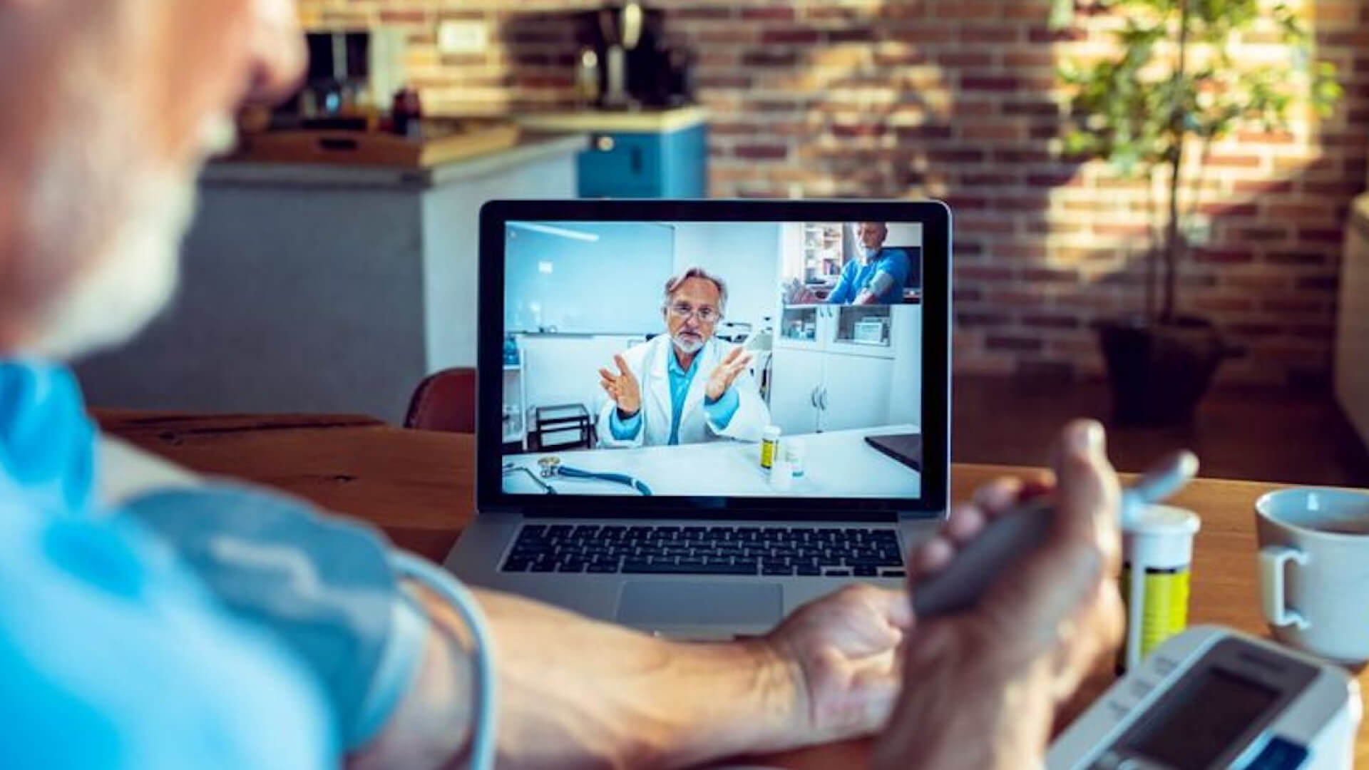 a man using a laptop for video consultation with a doctor to monitor his blood pressure