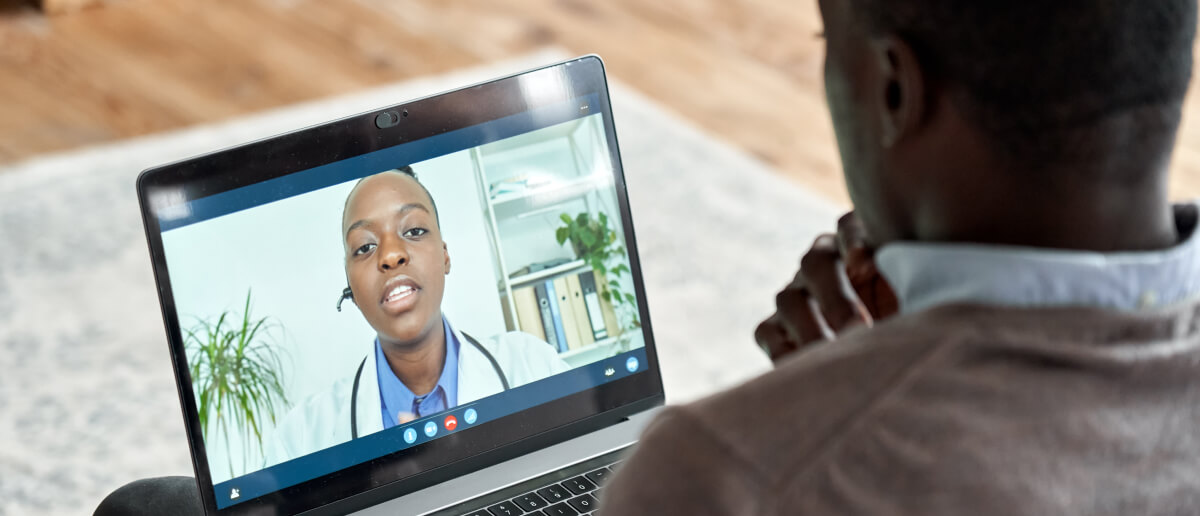 a man on a video conferencing with a doctor